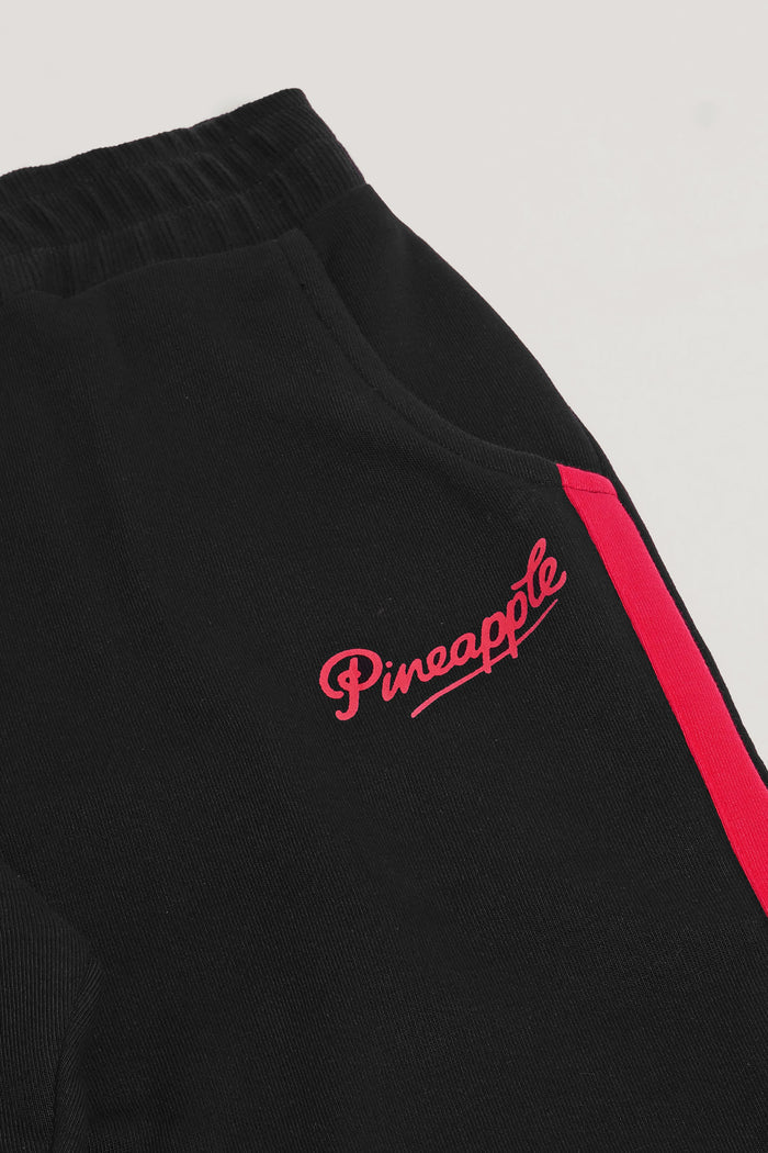 Detail picture of joggers' pocket and delicate red hip logo by Pineapple Dance.