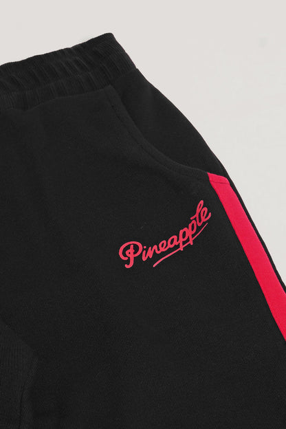 Detail picture of joggers' pocket and delicate red hip logo by Pineapple Dance.