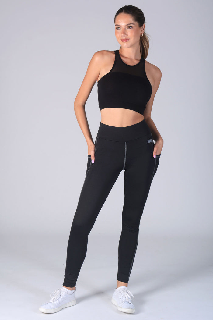 Woman wearing blacvk Pocket Leggings and black vest top