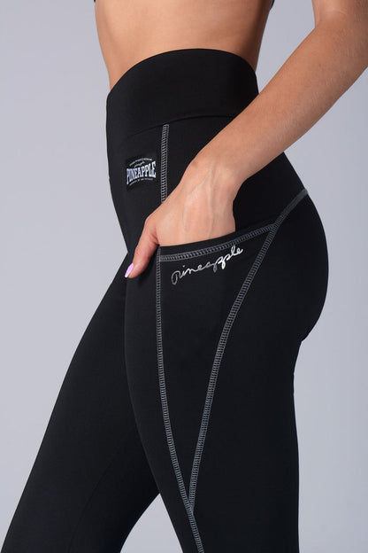 Logos on women's black leggings with pockets.