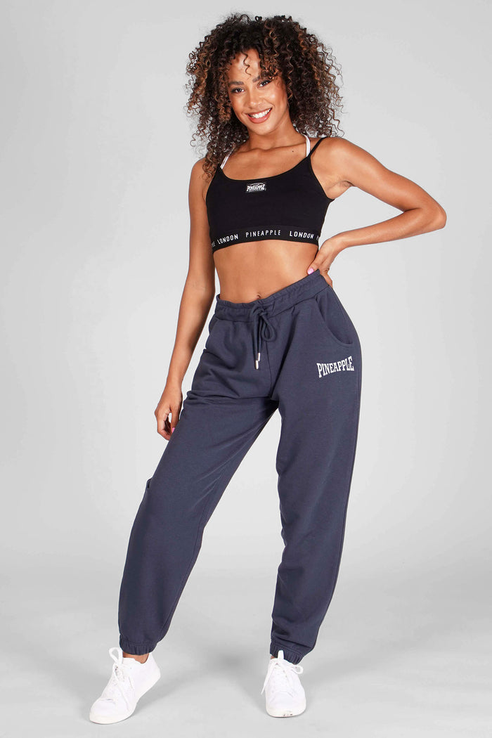 Woman wearing Charcoal Oversized Pocket Joggers and Black Bra Top with logo