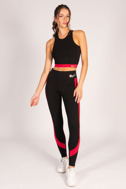 Women's black leggings with red paneling and matching yoga crop top on Kianna Louise.