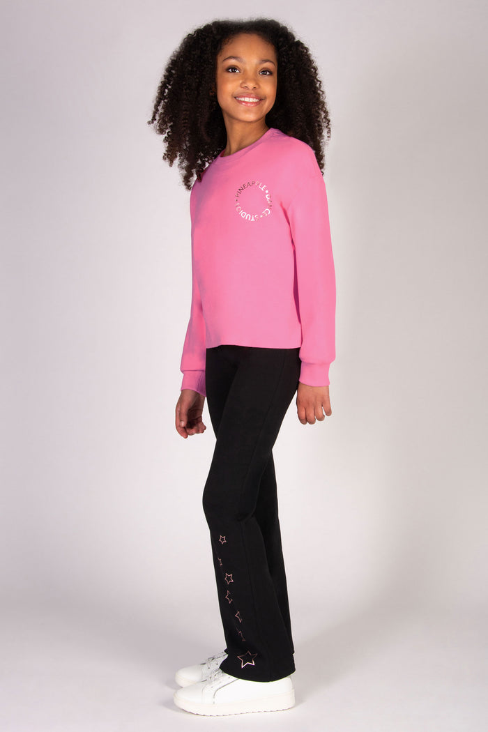 Girl wearing pink sweat top featuring baggy sleeve sand a loose comfy fit