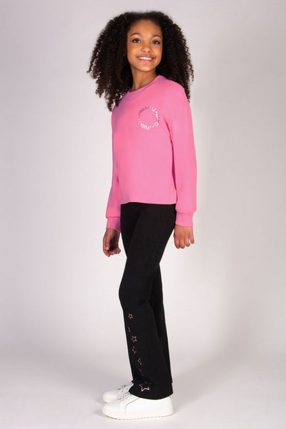 Girl wearing pink sweat top featuring baggy sleeve sand a loose comfy fit
