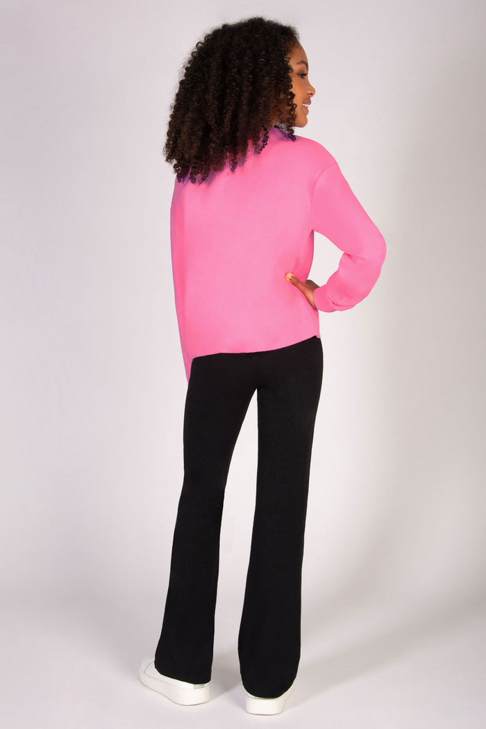 pink sweat top for girls paired with black flared trousers