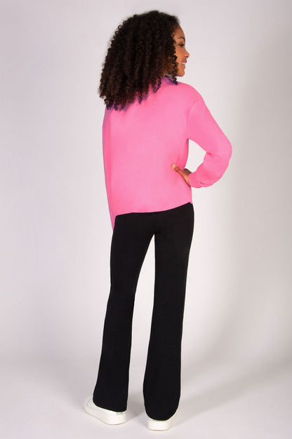 pink sweat top for girls paired with black flared trousers