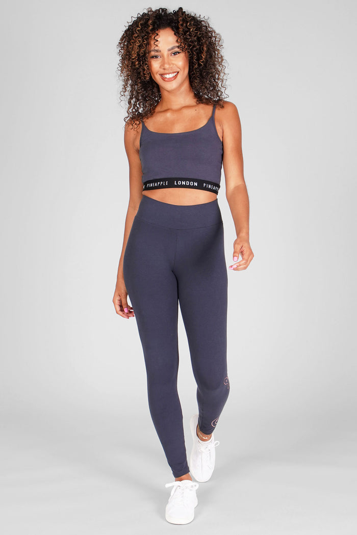 Woman wearing Charcoal Retro Foil Leggings and Charcoal Bra Top