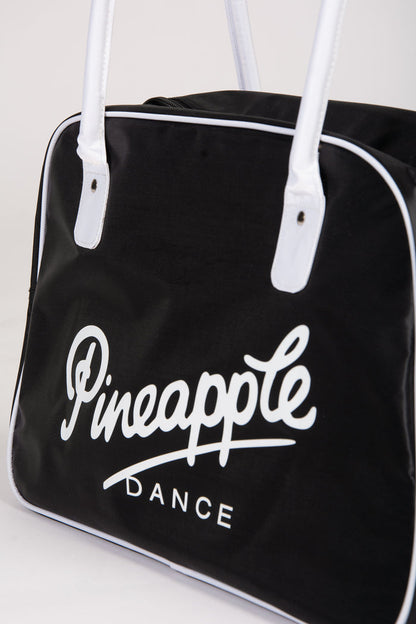 Black duffle bag with 'Pineapple Dance' logo on a white background