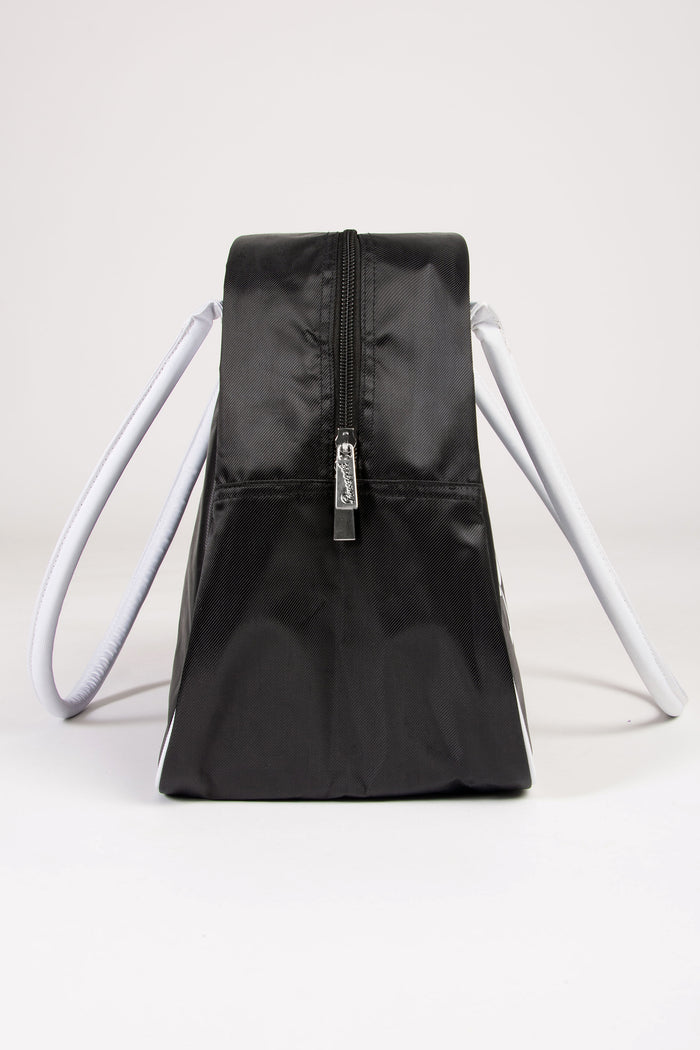Black duffle overnight bag with white handles, zips on a light grey background
