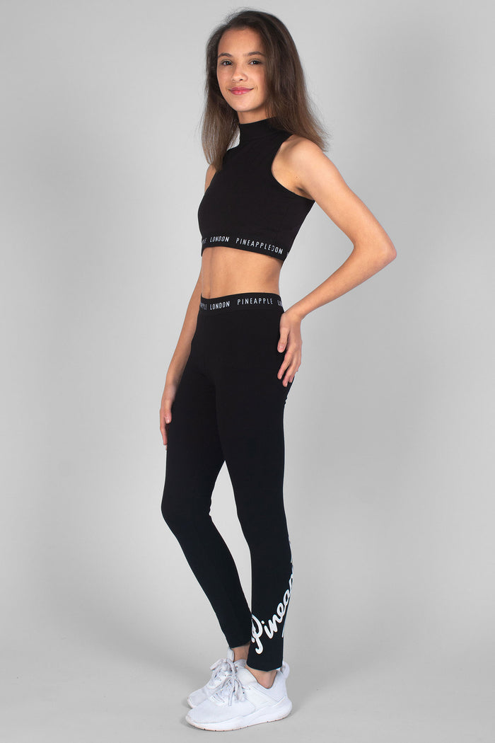 Girl wearing black Retro Leggings and sleeveless black Barbarella Crop Top