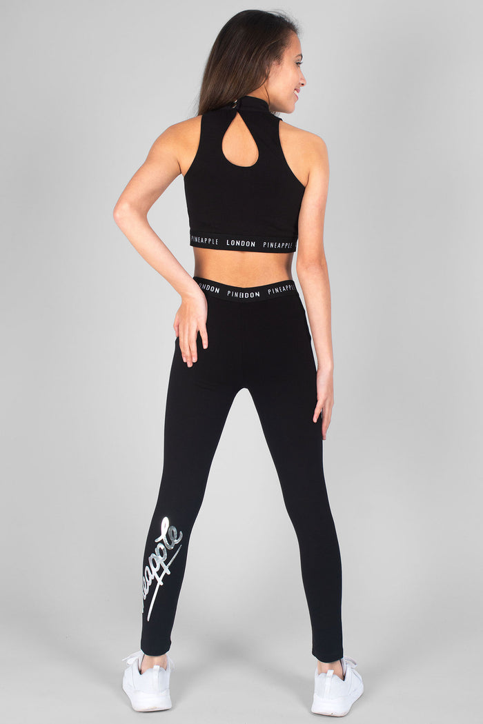 Girl wearing black Retro Leggings with logo and black Barbarella Crop Top