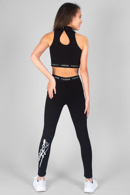 Girl wearing black Retro Leggings with logo and black Barbarella Crop Top