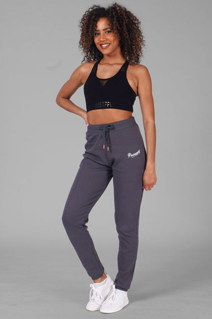 Woman wearing charcoal Retro Skinny Trousers and cropped vest top
