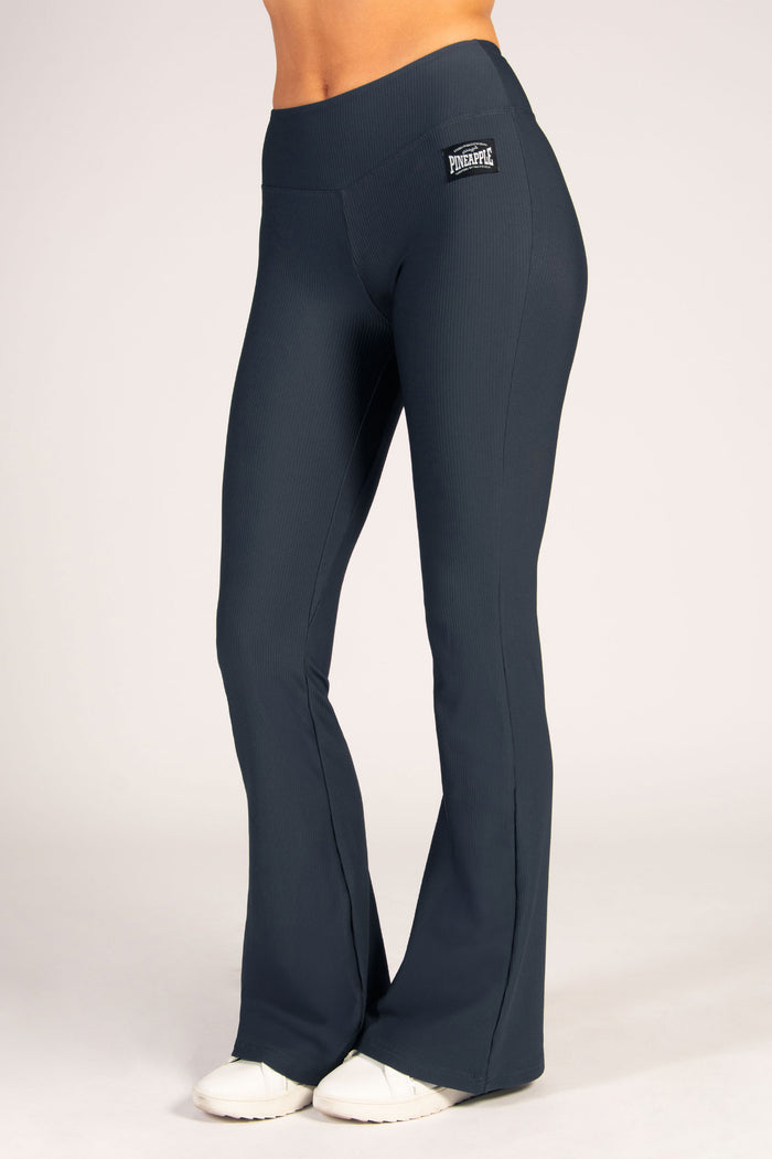 Women's rib flared leggings in dark grey featuring a wide v-shaped waistband for maximum security and comfort.