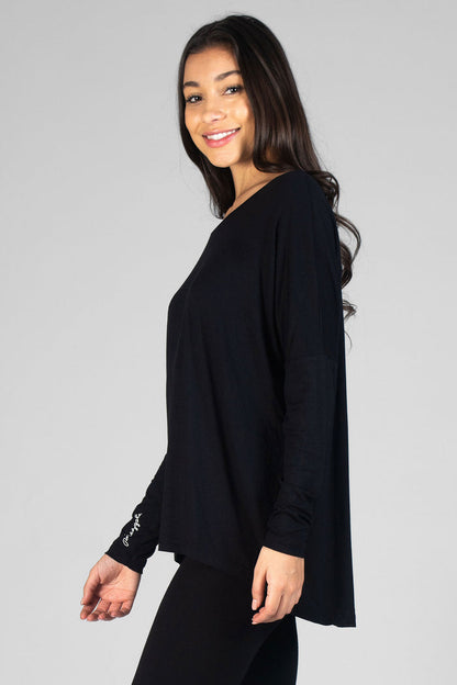 Woman wearing black Logo Long Sleeve Top