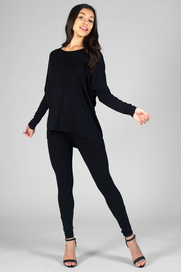 Woman wearing black Logo Long Sleeve Top and black leggings