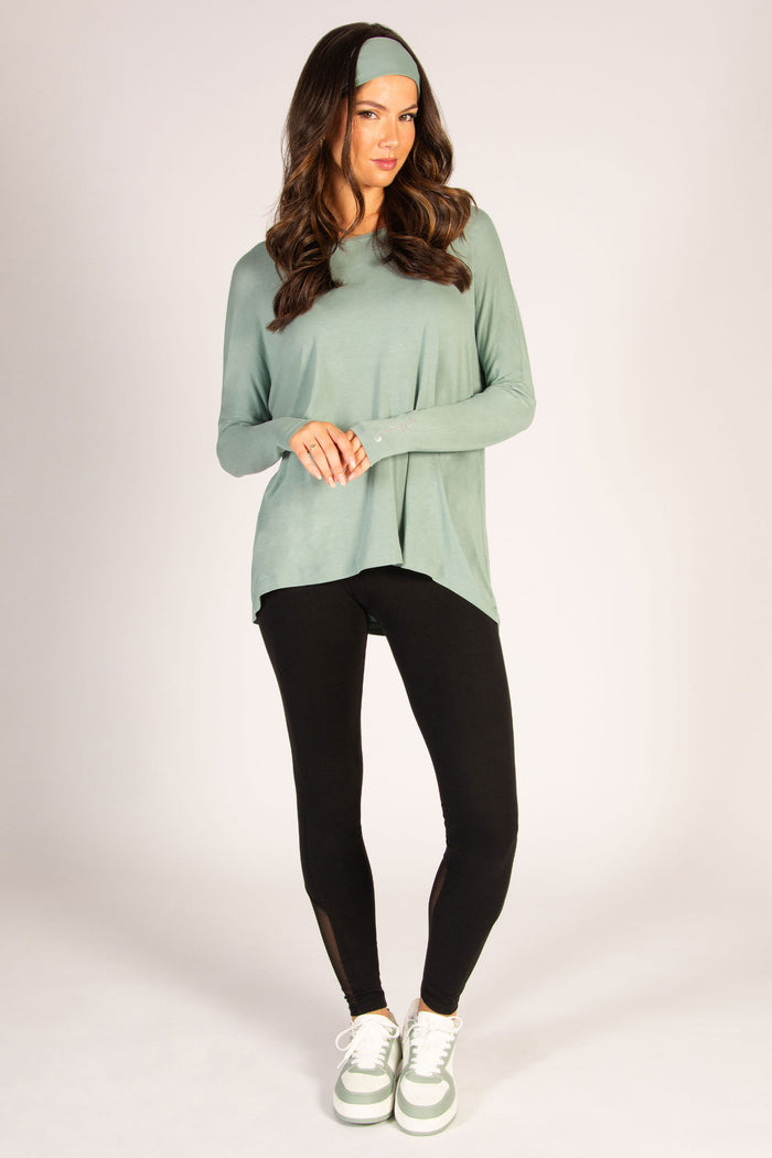Light green along sleeve top in soft viscose fabric, featuring a tight sleeve but loose, dipped back.