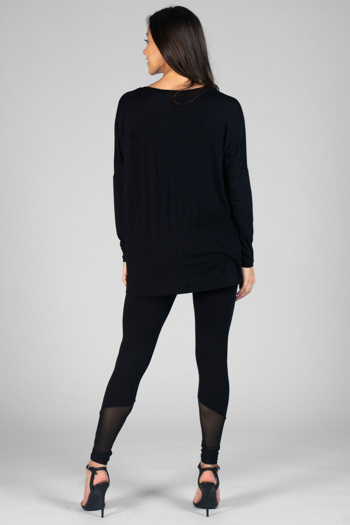 Woman wearing black Long Sleeve Top and black leggings