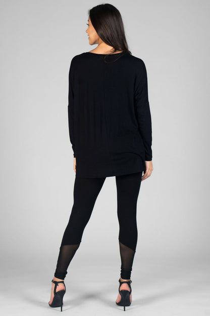 Woman wearing black Long Sleeve Top and black leggings