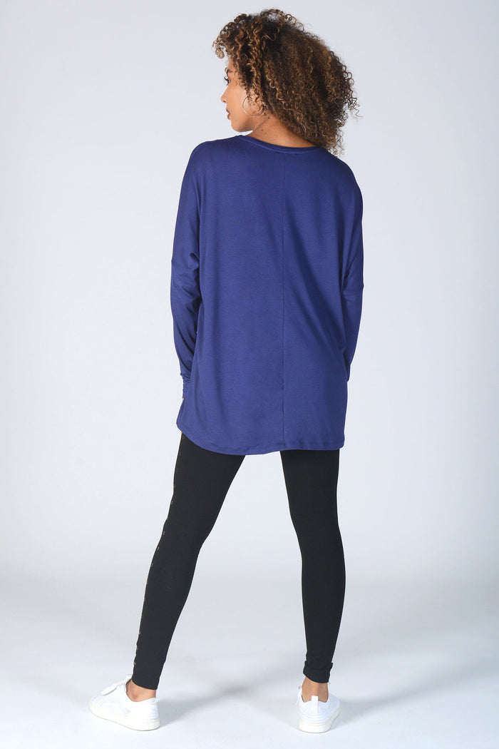Woman wearing loose fit navy Long Sleeve T-Shirt and black studded leggings