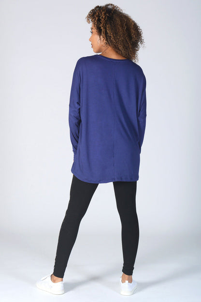 Woman wearing loose fit navy Long Sleeve T-Shirt and black studded leggings