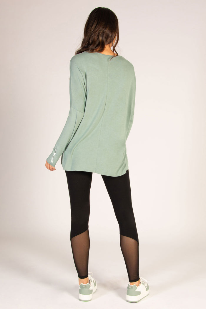 Women's long sleeve sage top with dipped back cut for a flattering fit.