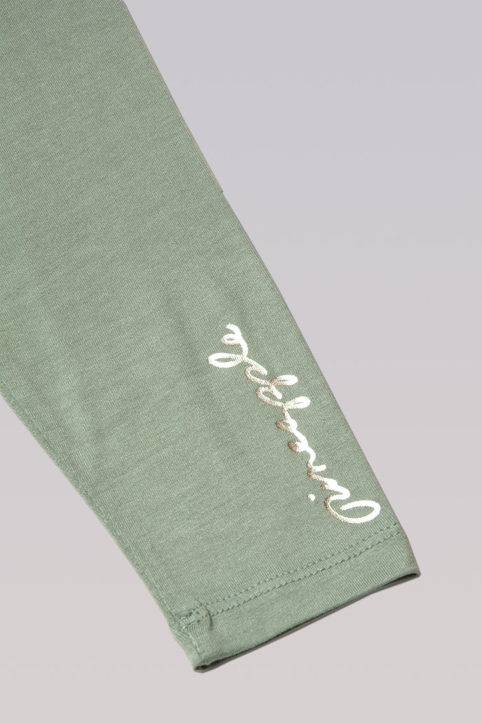 Detail picture of small Pineapple dancewear logo on the sleeve.