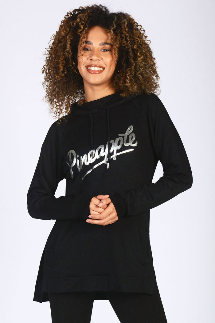 Alyce Justyne wearing basic black hoodie with Pineapple logo