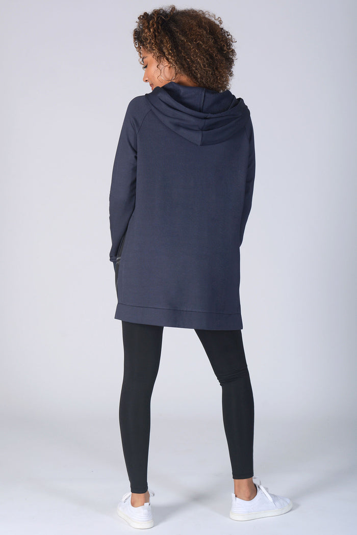 Woman wearing charcoal longline hoodie and black leggings