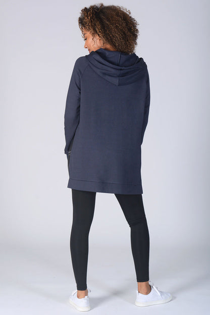 Woman wearing charcoal longline hoodie and black leggings