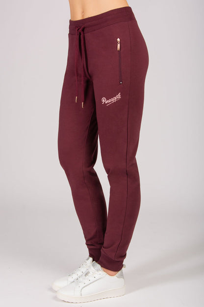 Women's burgundy skinny zip joggers with side zip pockets and drawstrings