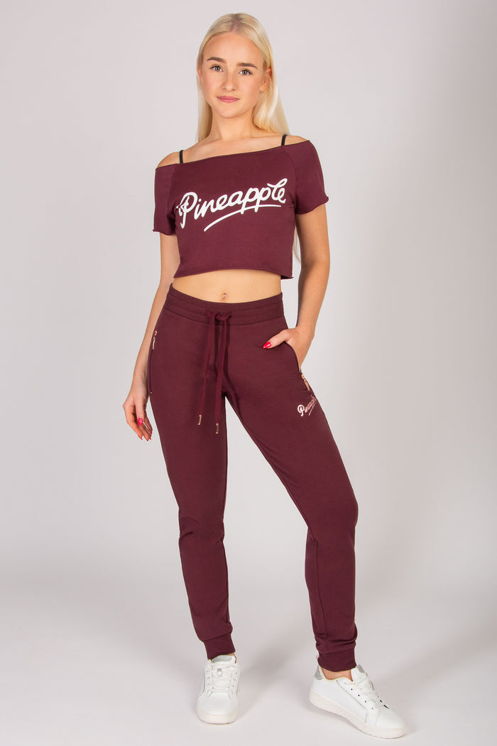 women's burgundy skinny zip joggers with side pockets and elasticated waistband