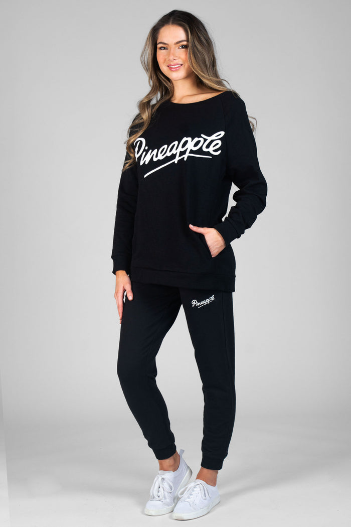Woman wearing black Zip Skinny Joggers and logo black Monster Sweater
