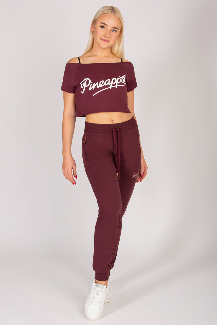 women's burgundy skinny zip joggers with side pockets and elasticated waistband