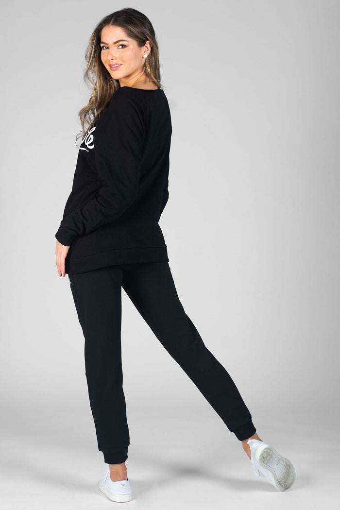 Woman wearing black Zip Skinny Joggers and black oversized Monster Sweater