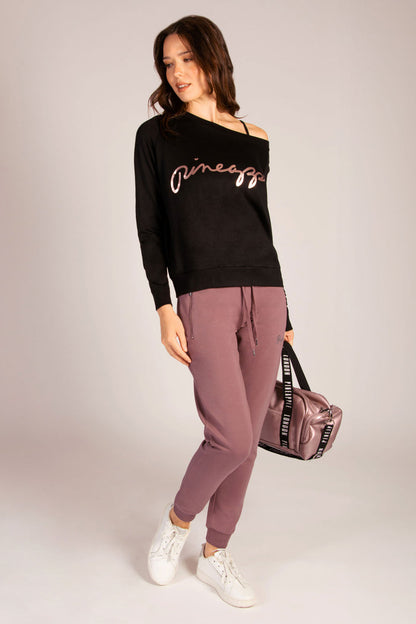 Pineapple raisonette yoga outfit on Martyna Balsam featuring skinny joggers and rose gold dance bag.