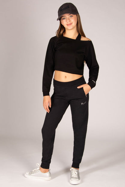 Girls black skinny joggers with two zip pockets worn with off-shoulder sweat top