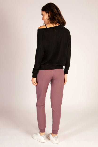 Women's grape colour joggers by Pineapple Dance Studios paired with black jumper.