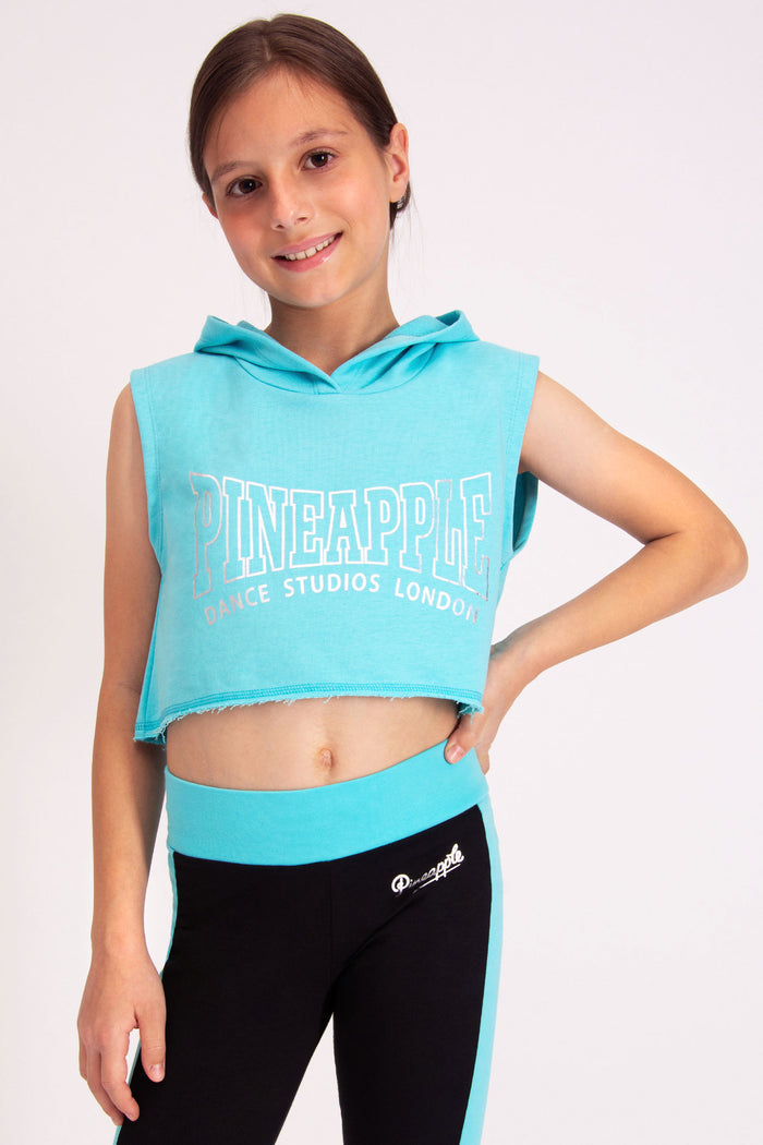 Girls' turquoise sleeveless hoodie in cropped fit featuring a Pineapple Dance Studios London chest print.