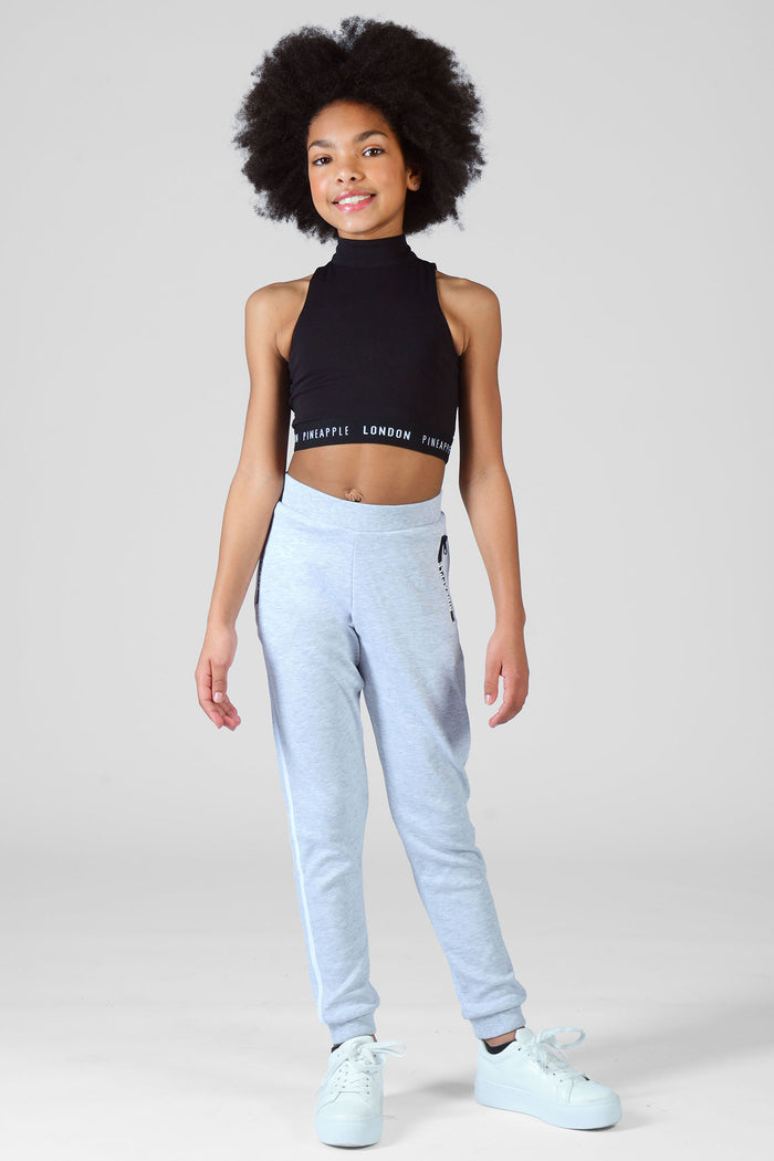 Girl wearing grey Stripe Joggers and crop Barbarella black top