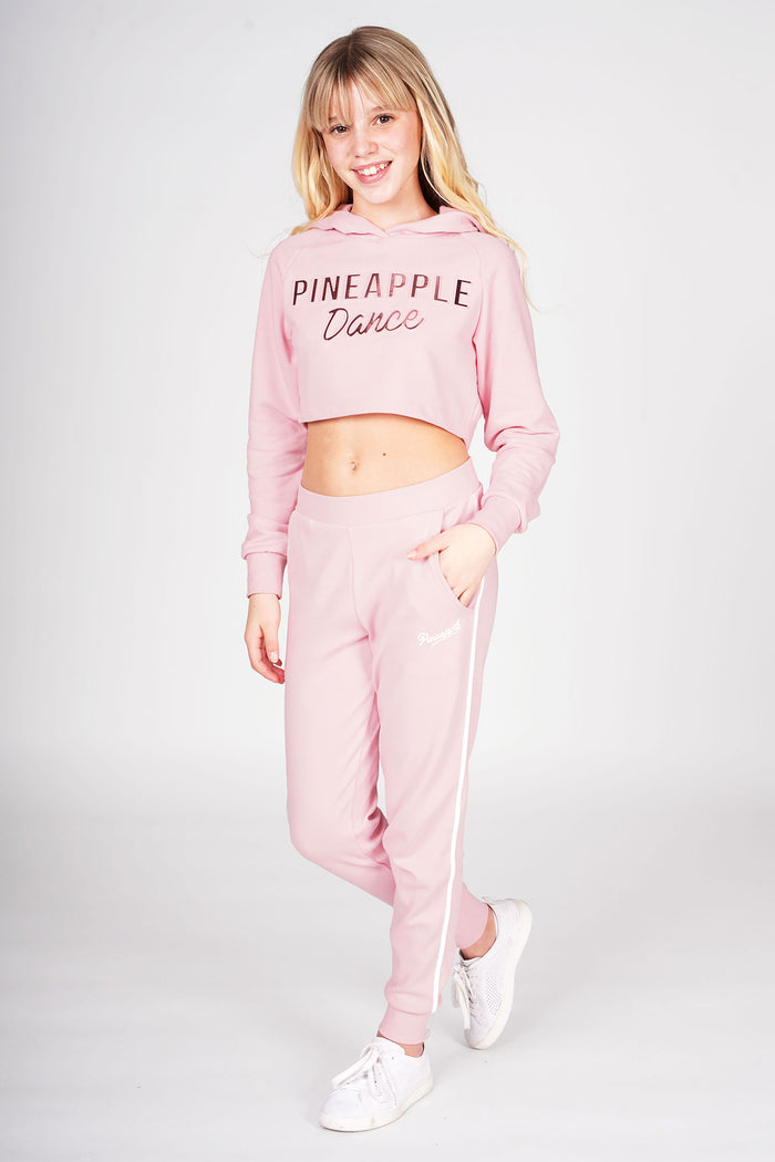 Girl wearing Pink Stripe Pocket Joggers with white stripe and pink embossed crop hoodie