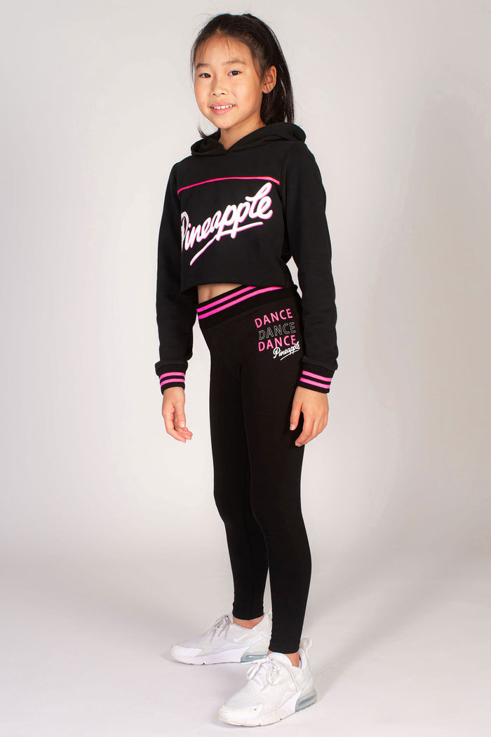 Girls' black stripe rib band leggings paired with black stripe logo crop hoodie by Pineapple.