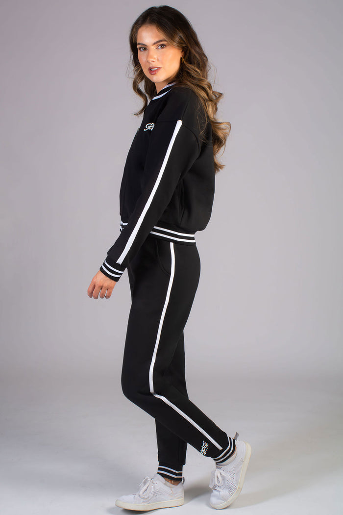Kianna Louise wearing Pineapple black matching set featuring a stripe rib cuff joggers for women and a matching soft bomber jacket