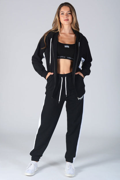 Woman wearing black Zip Hoodie and matching jogging trousers with white drawstring hood and waist
