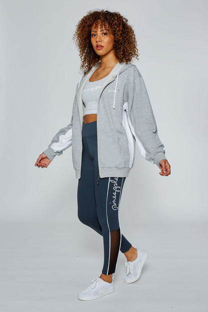 Woman wearing Grey Marl Stripe Zip Hoodie with grey Racer Midi Crop Top and charcoal Piping Leggings