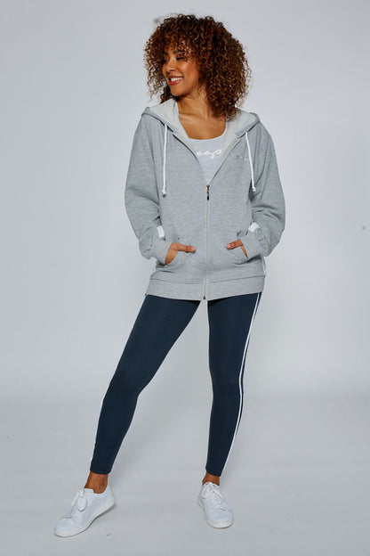 Woman wearing Grey Marl Stripe Zip Hoodie and charcoal Leggings with white piping