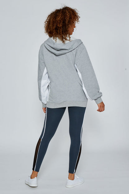 Woman wearing Grey Marl Stripe Zip Hoodie and charcoal Leggings with white piping