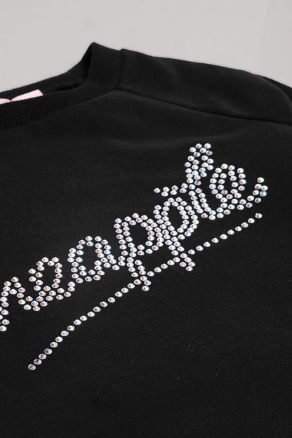 Detail of diamantés on black oversized sweatshirt