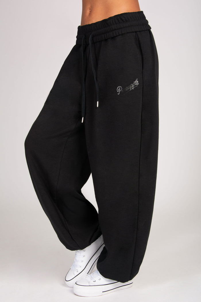 Detailed view of extra baggy black joggers with spacious pockets.