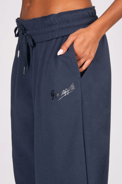 Navy blue sweatpants with pockets on a white background